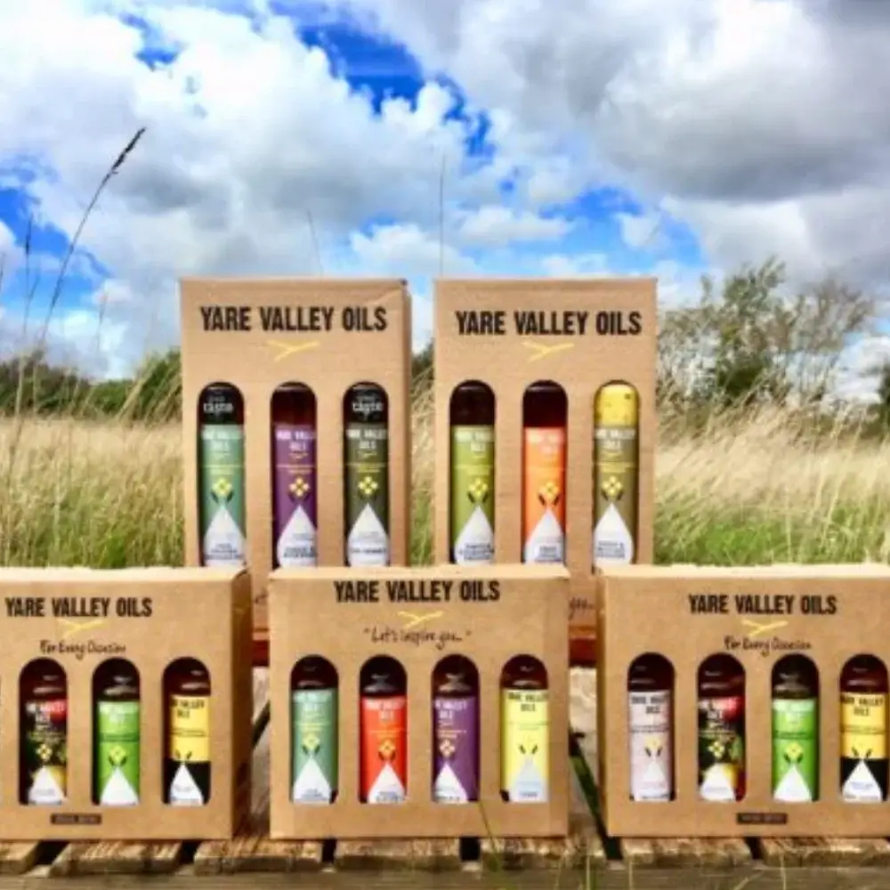 Yare Valley Oils gift boxes displayed outdoors, featuring assorted cold pressed rapeseed oils and infused oil flavours.