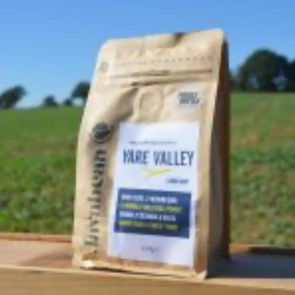 Yare Valley gluten free mayonnaise mix displayed outdoors with countryside fields in the background.