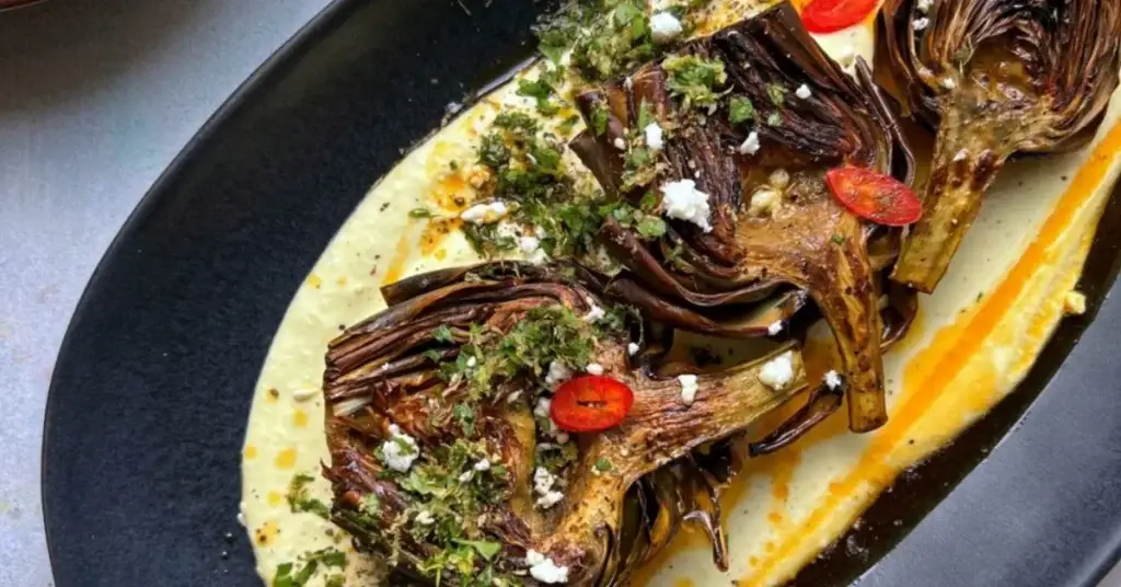 Roasted artichokes served on a creamy sauce with herbs, chilli and seasoning.