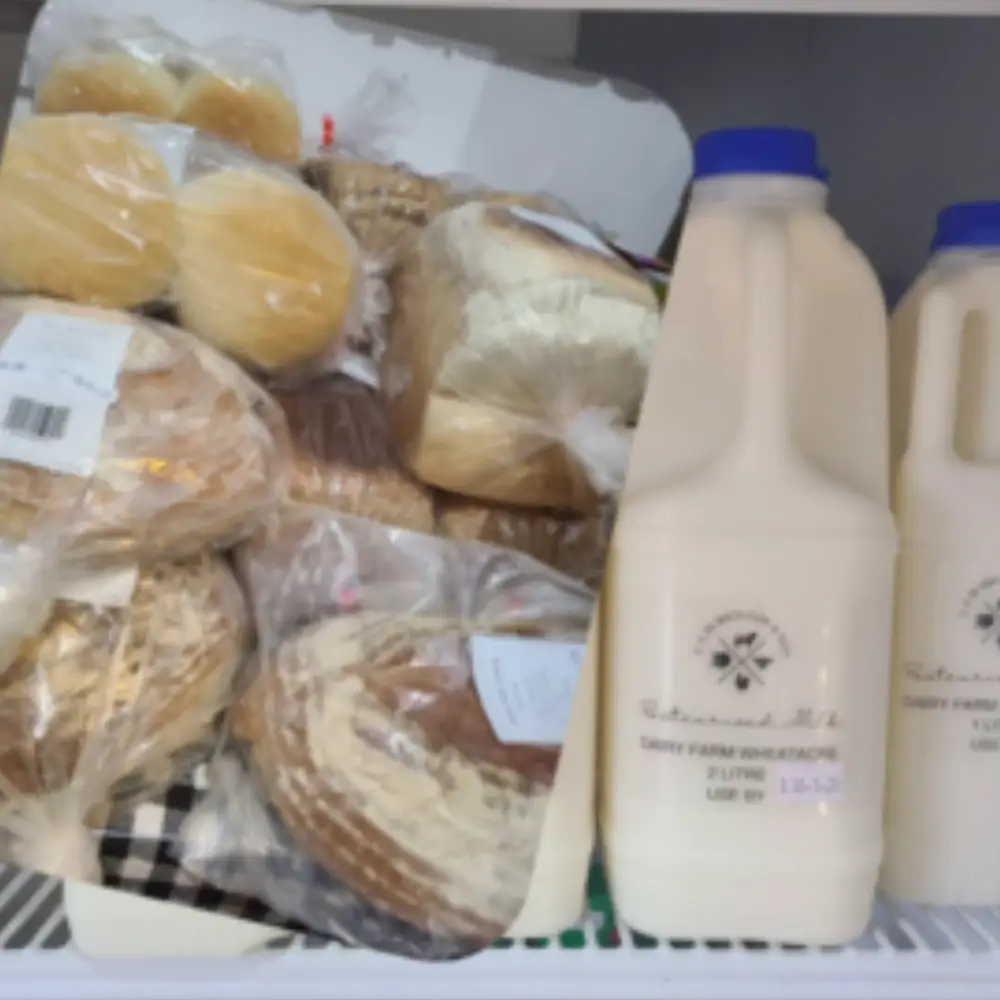Fresh bread, potatoes and local milk displayed inside the Yare Valley farm shop.