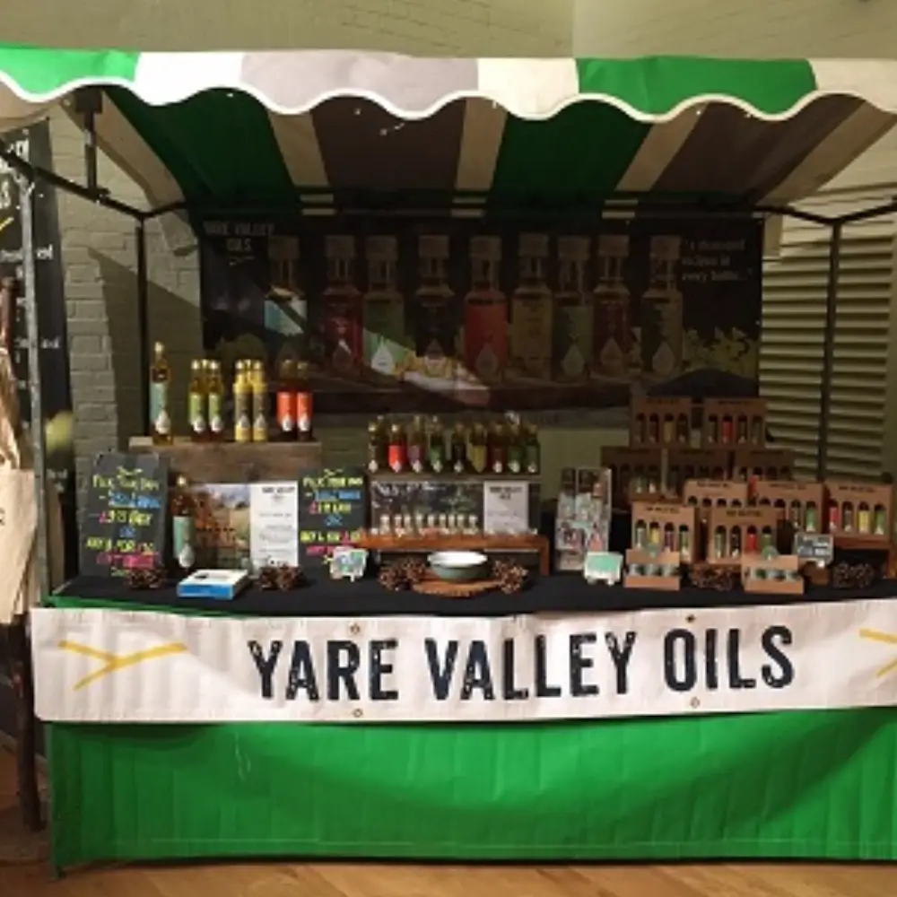 Yare Valley Oils market stall displaying locally produced rapeseed oils, dressings and farm-made products.